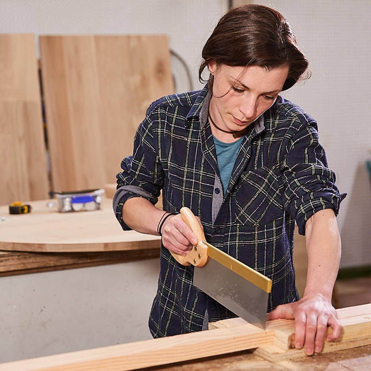 A furniture maker with saw