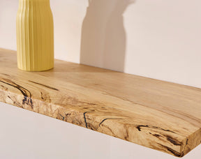 A vase on a floating wooden shelf made of spalted hornbeam wood