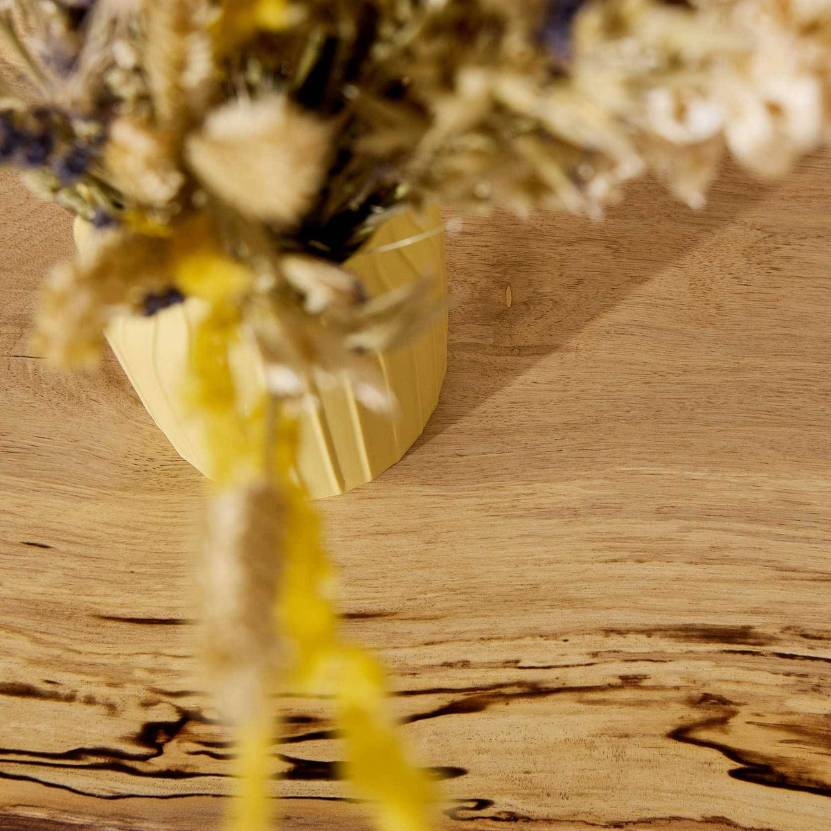 A vase on a floating wooden shelf made of spalted hornbeam wood