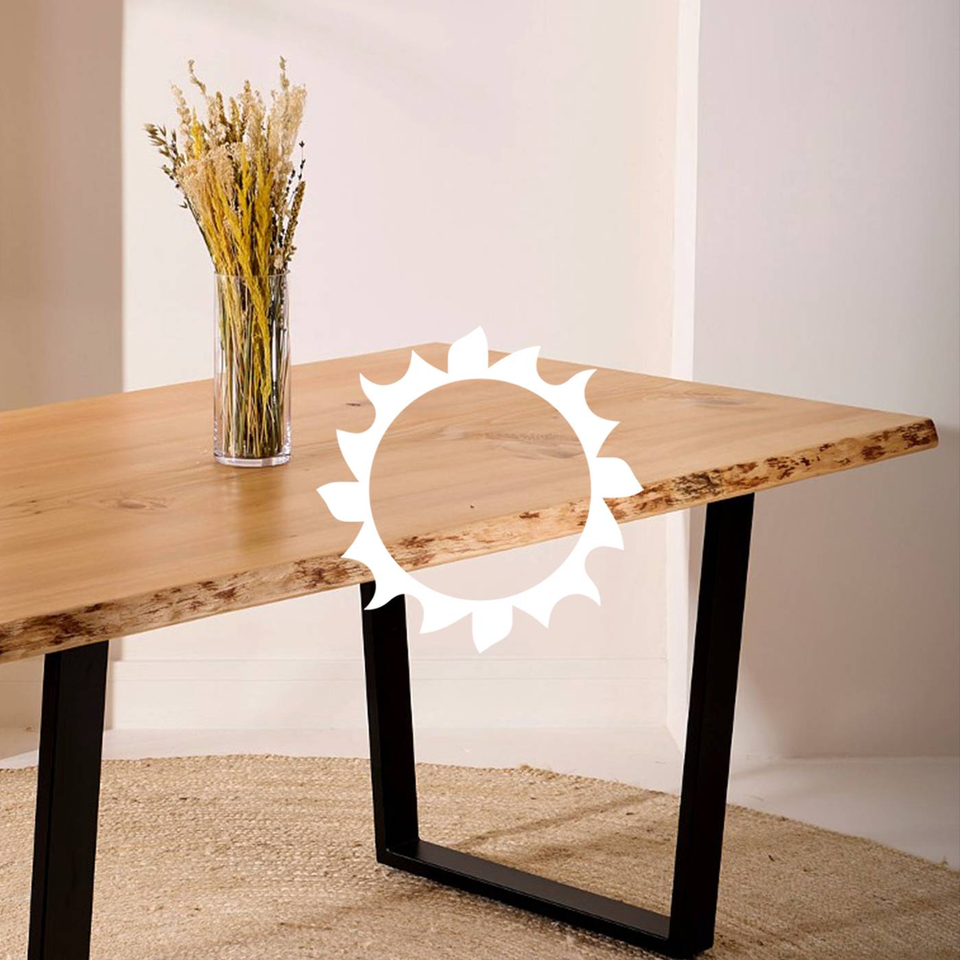 Wooden table with black metal legs with vase of dried flowers